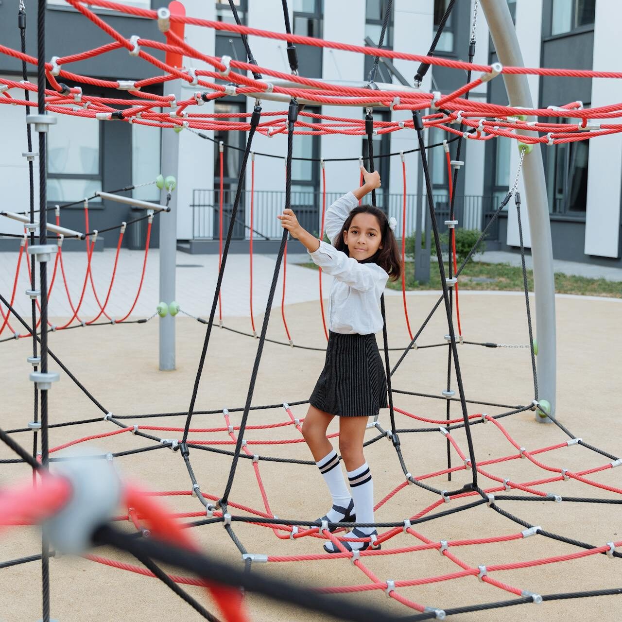 little girl playing on school playground little girl playing on school playground