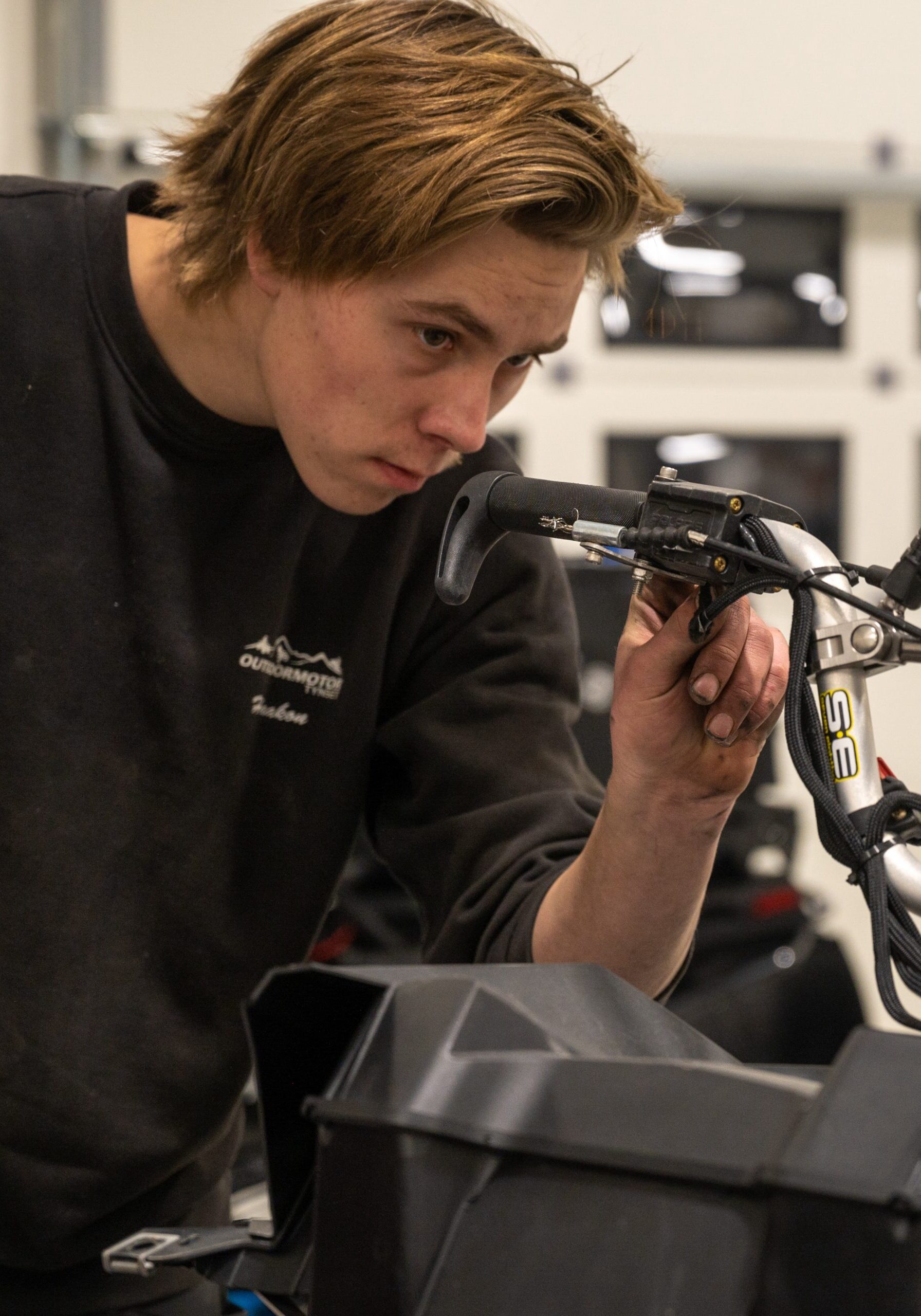 Tynset,,Norway,-,Nov,12,,2020:,A,Mechanic,At,Outdoormotor TYNSET, NORWAY - Nov 12, 2020: A mechanic at Outdoormotor Tynset repairing a snowmobi